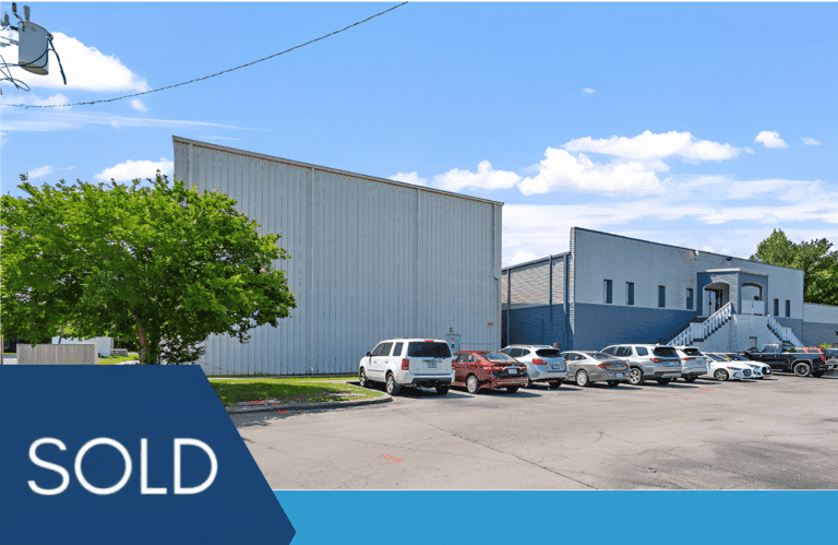 Sold commercial warehouse with parked cars