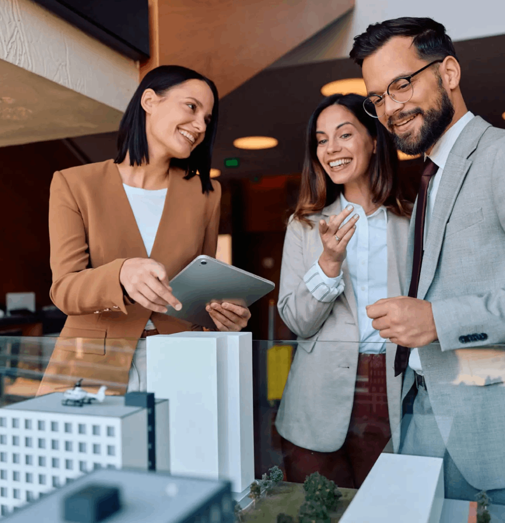 Professionals reviewing architectural building scale model